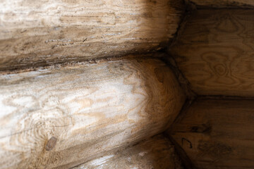 Close-up view of an interlocked wooden log wall showcasing natural textures