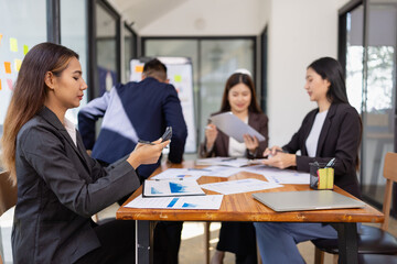 Group of Asian business working plan analysis project brainstorm in modern office, Asian businesspeople team working together, Business startup and company strategy planning concept.

