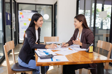 Businesswomen working plan analysis project brainstorm in modern office, Asian businesspeople team working together, Business startup and company strategy planning concept.