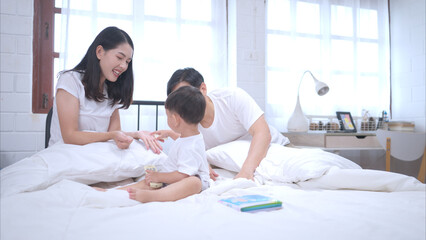 Before putting the kids to bed, parents, and kid unwind and play in the bedroom