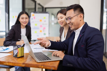 Group of Asian business working plan analysis project brainstorm in modern office, Asian...