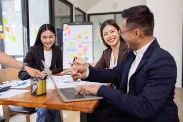 Group of Asian business working plan analysis project brainstorm in modern office, Asian businesspeople team working together, Business startup and company strategy planning concept.
