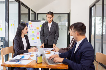 Group of Asian business working plan analysis project brainstorm in modern office, Asian businesspeople team working together, Business startup and company strategy planning concept.
