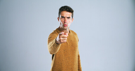 Portrait, pointing to you and man with threat, blame and selection on white studio background. Angry, person and model with hand gesture, fight and mockup space with decision and accountability