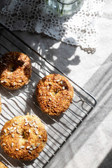 Healthy homemade oat bagels on rustic sunny background. Place for text.