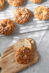 Healthy homemade oat bagels on rustic sunny background. Place for text.