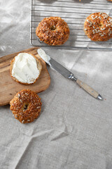 Healthy homemade oat bagels on rustic sunny background. Place for text.