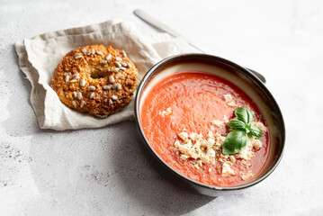 Gazpacho, cold tomato soup on grey table. Minimalistic, place for text