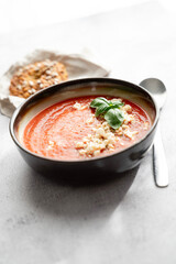 Gazpacho, cold tomato soup on grey table. Minimalistic, place for text