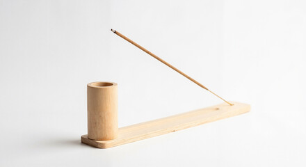 Naklejka premium Wooden incense holder with burning stick on white background