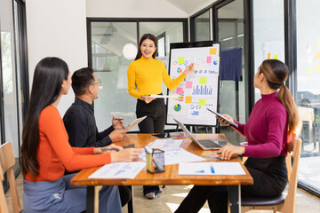Group of Asian business working analysis project brainstorm in modern office, Asian businesspeople...