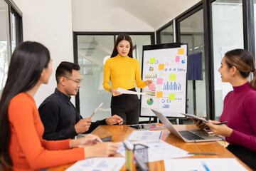 Group of Asian business working analysis project brainstorm in modern office, Asian businesspeople team working together, Business startup and company strategy planning concept.