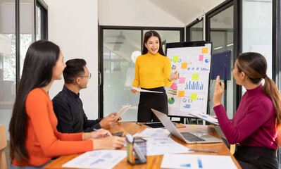 Group of Asian business working analysis project brainstorm in modern office, Asian businesspeople team working together, Business startup and company strategy planning concept.