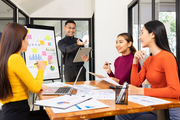 Group of Asian business working analysis project brainstorm in modern office, Asian businesspeople team working together, Business startup and company strategy planning concept.