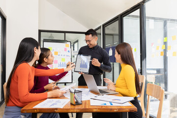 Group of Asian business working analysis project brainstorm in modern office, Asian businesspeople team working together, Business startup and company strategy planning concept.