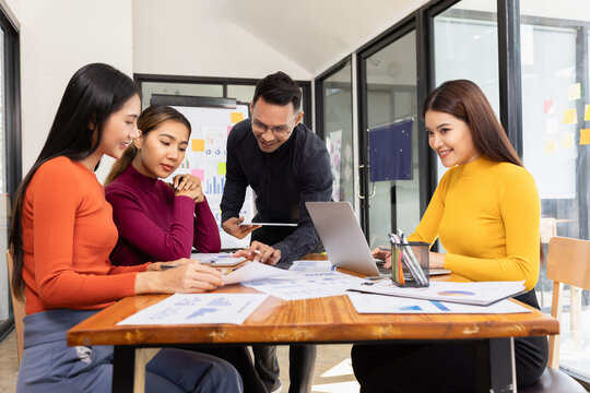 Group of Asian business working analysis project brainstorm in modern office, Asian businesspeople team working together, Business startup and company strategy planning concept.