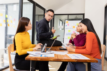 Group of Asian business working analysis project brainstorm in modern office, Asian businesspeople team working together, Business startup and company strategy planning concept.