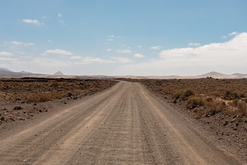 Desert road in Fuerteventura under blue sky