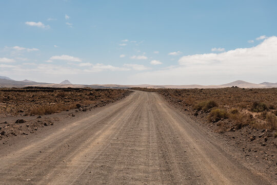 Desert road in Fuerteventura under blue sky
