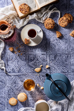 Cozy tea and coffee scene with cookies and book