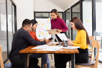 Group of Asian business working analysis project brainstorm in modern office, Asian businesspeople team working together, Business startup and company strategy planning concept.