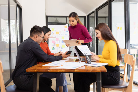 Group of Asian business working analysis project brainstorm in modern office, Asian businesspeople team working together, Business startup and company strategy planning concept.