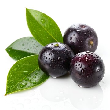 Freshly picked acai berries with vibrant green leaves and water droplets on a white background.