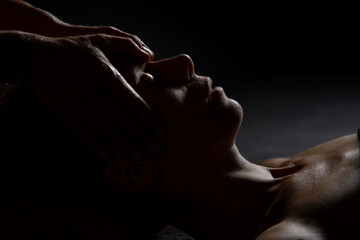 facial massage with dark background