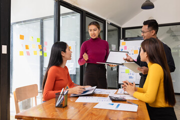 Obraz premium Group of Asian business people working together to presentation with dashboard analysis data management a meeting table in office, Business investment metrics or planning concept. 