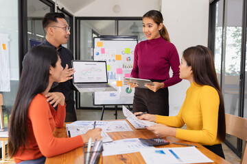 Group of Asian business people working together to presentation with dashboard analysis data management a meeting table in office, Business investment metrics or planning concept. 