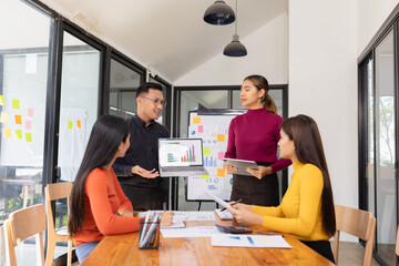 Group of Asian business people working together to presentation with dashboard analysis data management a meeting table in office, Business investment metrics or planning concept. 