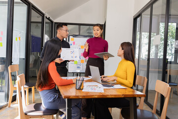 Group of Asian business people working together to presentation with dashboard analysis data management a meeting table in office, Business investment metrics or planning concept. 