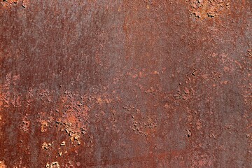 Background, texture rusty metal with islands of remains of peeling cracked brown paint