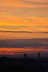 Burning sunset sky over Belgrade skyline silhouettes. Urban evening mood