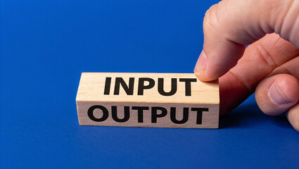 Input output concept wooden blocks business process hand