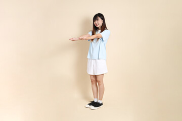 20s Asian Woman in Light Blue Shirt and White Shorts