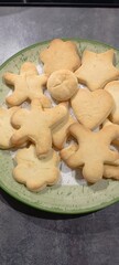 figured homemade cookies of different shapes on a flat plate. Mobile photo