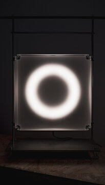 White ring light behind translucent acrylic plate