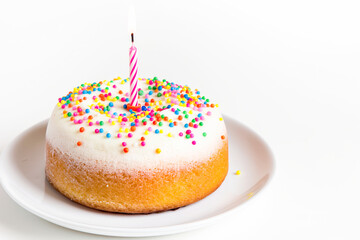 Birthday cake with one candle on white background