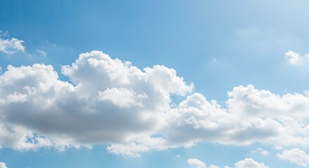 Fototapeta premium White Cumulus Clouds Against a Bright Blue Sky with Sunshine and Natural Beauty