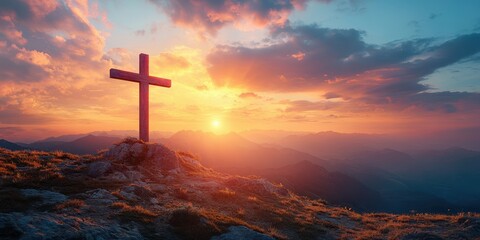 Obraz premium Sunrise view over mountains with a cross silhouette standing tall against a colorful sky
