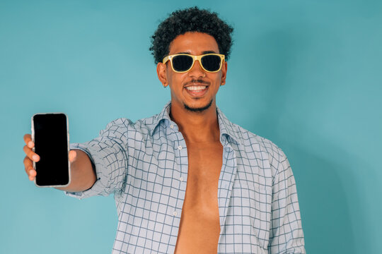 man isolated on background with phone and sunglasses in summer