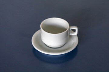 elegant minimalist white ceramic cup isolated on smooth surface