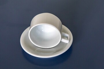 elegant minimalist white ceramic cup isolated on smooth surface