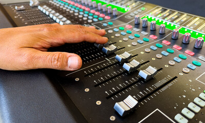 Sliders and buttons on Audio Mixing Desk at live event.