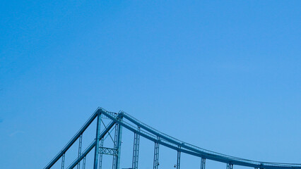 Minimalist pedestrian bridge underframe photographed from below in urban setting.