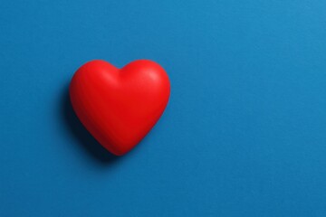 Minimalist image of red heart on blue background,  love, health, emotion, valentine day