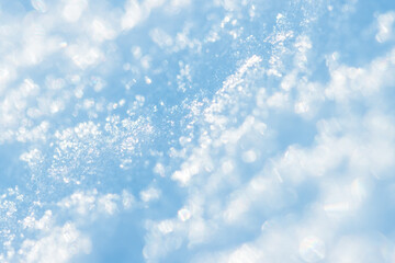 Snow close-up. Winter background with snow texture and beautiful bokeh. Shallow depth of field and blur. Perfect for Christmas and New Year design. View with copy space.