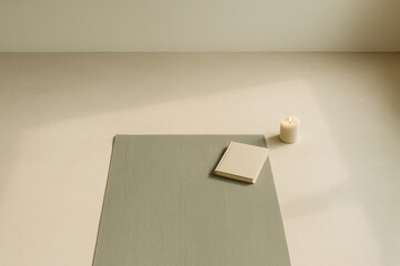 Yoga mat, candle, and notebook arranged in minimalist space with soft natural light. generative AI