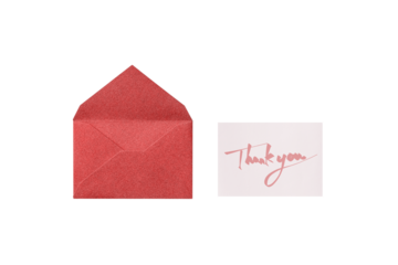 A cutout of a red lamé envelope with a pink handwritten thank you message card, overhead view